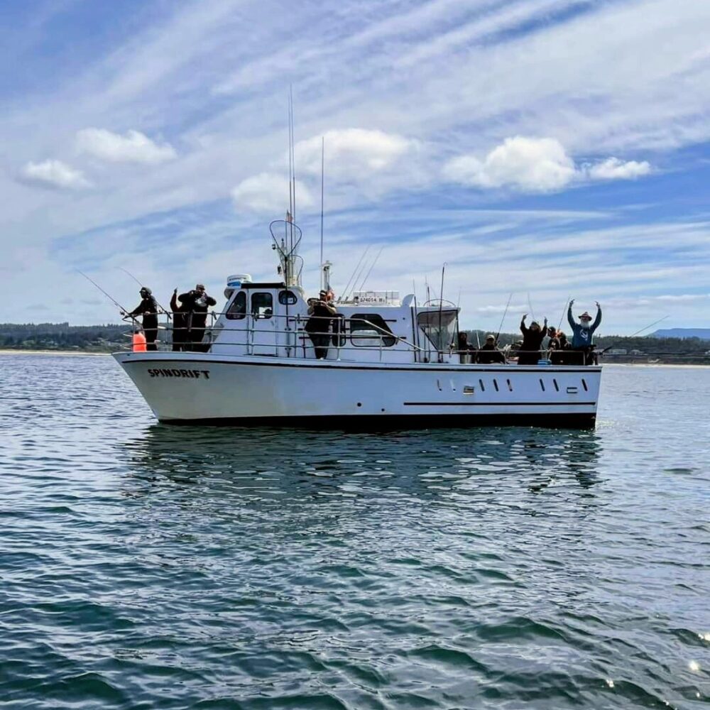 Charter boat Spindrift out fishing with excited passengers on board